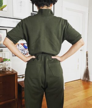 Jasika Nicole Instagram - Sometimes inspiration takes on a whole life of its own. Last summer I saved a tik tok of a woman in a really cute knit shorts jumpsuit in the hopes of recreating it, but by the time I got to making it, it was winter so I amended lots of details to accommodate the cooler weather and I ended up with something completely different! I love love love how this turned out- it is SUPER comfortable, it’s sporty but still feels really chic, and it doesn’t look (or fit) quite like anything I’ve seen in RTW. I used organic cotton sweatshirt fabric and matching rib knit from @wearethefabricstore and it’s every bit as good as you would imagine- it’s soft, the color is vivid, and the matching rib (so hard to find in fabric stores) is just icing on the cake. This ribbing is sold in traditional yardage, and I just folded it over double and sewed the edges to turn it into ankle cuffs, a collar, and details on the pockets. The jumpsuit is completely Frankensteined- I used a vintage stretch and sew women’s rugby pattern, a vintage stretch jumpsuit pattern, the pockets and leg shape of the Hudson pants, and then a little spiritual trueing to kind of meld everything together. Thankfully it actually worked! Most important pattern adjustment was elongating the front tab so that it would be wide enough to step into through the neck and it works like a charm. This has been a great make to enter into 2023 and I can already tell I will be wearing it alot and might have to make another one- maybe in a liberty print sweatshirt fabric. I took some action shots so you could see how comfy it is when I KICK (“I’m FIFTY!”) and pretend to run very hard 😂 shoes are RTW Aasics!