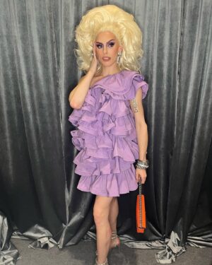 Jasmine Kennedie Instagram - Rupaul says she doesn’t want to see anymore f*^king @hm ….. so I wore it anyway 😂 ! Such an amazing time at @rupaulsdragconuk this year!! Also a huge shout out/thank you  to @lewjizzlefoshizzle for helping me with my booth as well as gifting me this @marcjacobs bag!!! Such an amazing dragcon weekend!! Til next time 🇬🇧 

Hair: @theonlymadd 
Outfit: @hm metaverse collection 
Bag: @marcjacobs 
Ft: @teletubbieshq 

#dragcon #dragconuk #showgirl #frilly #h&m #trans #transwoman #jasminekennedie #rupaul #rpdr #rpdr14 #purple #wigs