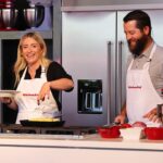 Jasmine Roth Instagram - We did it again! 😊 Had the best time being a #KitchenAidAmbassador this weekend. Loved talking all things kitchens at the @seniorpgachamp as a guest of @kitchenaidusa. I got to watch some golf, explore a little bit of Michigan, meet so many great people, and even cook in front of a crowd with @brettrothofficial - yikes! This year’s recipe was so fun because it’s a salad even @themeatatarian approves of, which you know is a big deal. And it’s perfect for meal prep or even party prep for a BBQ! So without further introduction, here’s the recipe: “Viral BBQ Chicken Meal Prep Salad Jar”. Ingredients: - 2 Boneless Skinless Chicken Breasts - BBQ Sauce - Brett likes “Lillies Smoky Barbeque Sauce” right now - Olive Oil - Salt & Pepper - 2 Ears of Grilled Corn, Cuff off the Cob - Diced Red Onion (Optional) - Diced Red Pepper - Cilantro - Fresh Spinach - Diced Cotija Cheese - Wild Rice Method: Dressing - Brett’s not a big fan of vinegar, so we’re keeping our dressing really simple.  Whisk together 1 cup bbq sauce, 1/2 cup olive oil, 1 tsp garlic powder, salt, pepper.  Chill covered in refrigerator while prepping the rest of the food.  If you like vinegar like I do, you can add apple cider vinegar to this.  If you wanted to change this up, you could use buffalo sauce instead of bbq sauce. Pull chicken breasts, grill corn and cut off cob, cook wild rice, dice red onion, red pepper, and cilantro, lightly chop spinach. To assemble, start by adding 1/4 cup of dressing in each jar.  Layer red pepper, red onion, corn, cheese, spinach, rice, chicken, and cilantro.  Chill in the fridge until ready to enjoy! #BuildYourHappy #RothFamilyStory #KitchenaidSrPGA @pga @pgatourchampions @pgatour