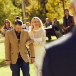 Jennifer Holland Instagram - After over 7 years together, I finally married the love of my life, @jenniferlholland. What an incredible, beautiful, stunning day surrounded by the most wonderful family and friends in the world. And, yes, that’s a moose that showed up as the ceremony began! And also, yes, @originalfunko made our wedding cake toppers designed on our actual tux and gown (Jenn wouldn’t let me see them before the wedding because her dress was too perfectly done!) And, yes, we had Sunday fun festivities including a Marvel vs DC softball game (@michael_rooker played on both teams!) Thanks to @eksevents for planning everything! Photos 1, 3, 5, 7, 8, 9 & 10 by @jonnymarlow Photos 4 & 6 by @jessmigliophoto Stylings by @carrielauren @lexfordays @victordevita Jenn’s Hair by @lisasatornhair Jenn’s Makeup by @rachelgoodwinmakeup My grooming by @louisemooninc