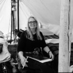 Jennifer Landon Instagram – Without a doubt the unsung hero of any production is the Script Supervisor, colloquially know as, ‘Scripty’. 
To summarize their job is nearly impossible, because they don’t have one job. They have ten.
 Not only are they tracking continuity (which means making sure sets, costumes, props, actions, hair, and makeup stay consistent  from one take to the next and  across scenes and episodes), they have also made sure you’ve said your lines correctly, documented camera movement, lenses/filters used, number of takes, written the director’s notes on each take for the edit, timed the freaking scenes and I’m not capturing half of it (breaking down a script before shooting is another mountain as are the production reports at the end of the day). How they do their job without 4 extra sets of arms and eyes and 5 more hours in a day still baffles me. 
  From an actors’ perspective, the good ones know how to catch anything that might pull the audience out of a moment or do disservice to the writer, the great ones know how to do that while also allowing the actors and director to have enough freedom to bring the scenes to life. And the best ones do both of those things while offering emotional support, performance guidance if needed (they often know your characters arch better than you do), and friendship on the day.
 This lady here isn’t just one of the  best ones, she’s THE best one. 
The Mother of all Scriptys (@clarkgregg I believe you coined that)
@mellw2lls any set is a much more dreary place without you. 
#yellowstonetv #bts #scripty #scriptsupervisor
#crew