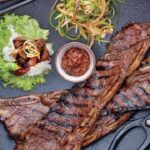 Judy Joo Instagram – Feast your eyes on the Ultimate Korean BBQ Beef Short Ribs (Galbi) 🇰🇷

Galbi is a classic grilled dish that marries Korea’s famed sweet and umami filled soy based marinade with the savoury smokiness of a charcoal grill. The two techniques create a bbq dish you won’t forget and the family will love. 🥩🔥

Elevate your Galbi with these tips:

Choose bone-in LA Galbi cut short ribs or trimmed boneless rib-eye steak for a succulent dish.

Use Asian or ripe pears in your marinade for an authentic Korean sweetness.

Fresh ginger and garlic bring aromatic nuances you won’t want to miss.

Dark brown sugar adds a richer, complex sweetness.

Roasted sesame oil imparts a nutty, toasty character.

Marinate the beef for at least 2 hours, or better yet, overnight, for the deepest flavours.

Serve with red or green lettuce leaves, perilla leaves, steamed white rice, spicy lettuce wrap sauce (ssamjang), spicy scallion salad, and kimchi for the complete Korean BBQ experience.

And remember, you can always adapt your Galbi using local ingredients you love and have available!

Head to the link in my bio for full ingredients and instructions, or visit Judyjoo.com 🙌
•
•
•
•
#chef #chefs #cook #cooking #cheflife #chefsofinstagram #foodart #foodblog #foodculture #foodgasm #foodie #foodiegram #foodielife #foodinspiration #foodlover #foodpassion #foodphotography #foodporn #foodstagram #gourmet #instafood #korea #koreanfood #truecooks #beef #beefshortribs #bbq #galbi #koreanbbq #koreanfoodmadesimple