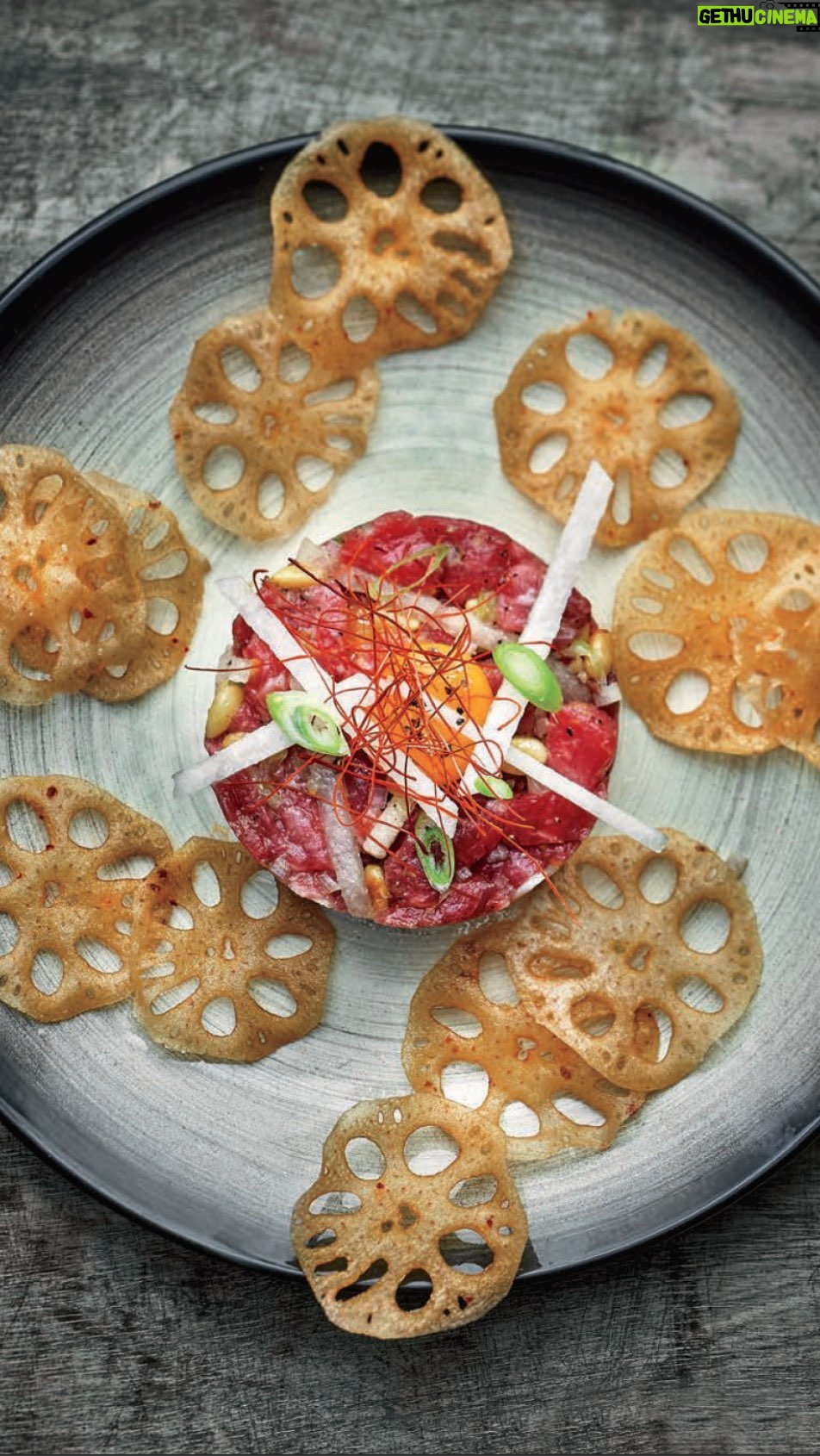 Judy Joo Instagram - Do you like steak tartare? Have you tried Korean Steak Tartare, known as Yukhwe? 🇰🇷🥩 Distinct from its Western counterpart, this Korean delicacy melds raw beef with the aromatic hint of sesame oil, the nuttiness of pine nuts, and the refreshing undertones of Asian pear, crafting a symphony of flavors and textures. For a genuine touch, go for the best quality and freshest fillet steak, and let the toasted sesame oil work its magic, infusing an authentic Korean aroma and taste. The julienned Asian pear adds a dash of sweetness and freshness, while toasted pine nuts lend a delicate earthy bite. The thinly sliced spring onions offer a pop of color and taste. If you plan to serve it later, keep lemon wedges on the side to ensure the beef’s vibrant color remains untouched, as the acidity will slightly “cook” the meat. For an exquisite finale, pair with lotus root chips as a delightful crispy croute. For the full culinary journey, visit the link in my bio or explore Judyjoo.com 🙌 • • • • #chef #cheflife #koreanfood #steaktartare #yukhwe #foodie #koreanfusion #foodpassion #asianpear #pinenuts #rawbeef #foodculture #authentickorean #foodpresentation #gourmet #instafood #koreantradition #JudyJoo #korea #korean #koreanfoodmadesimple #judyjoo #beef #meat #tartare