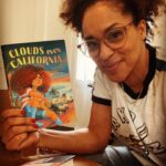 Karyn Parsons Instagram - They’re here!!! 🤗🤸🏽‍♂️ So cool to finally be able to hold the official hardcover in my hands! Official release is 7/11/2023, but you can click on the link in bio to order yours now! #CloudsOverCalifornia📘⛅️🛼🥰