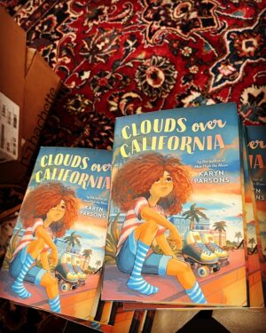 Karyn Parsons Instagram - They’re here!!! 🤗🤸🏽‍♂️
So cool to finally be able to hold the official hardcover in my hands!
Official release is 7/11/2023, but you can click on the link in bio to order yours now!
#CloudsOverCalifornia📘⛅️🛼🥰