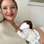 Kassandra Clementi Instagram - My girl, You are currently fast asleep on my chest and I’m sitting here, an hour and a half deep, breathing you all in. I never want to forget these moments with you. Of stillness and fullness and an infinity between us. You are a piece of me and all of me. One day you will grow and you will be a piece of me and all of you. But for now - we are here, intwined in each other in this chair, our warmth holding each others, your breath and mine meeting on our cheeks, sharing oxygen like we always have. The weight of your body slowing the rise and fall of my chest, just enough to sense our calm a little deeper. I would hold you forever if I could. But I know how you will grow, and oh how I want you to. I know that one day I will have to loosen my arms, let you breathe your breath into the world without me, maybe one day find your comfort in another, but I hope you always know that you will never outgrow my body, and that my chest will always be a home for you to come back to. Until then, we will be one and we will be here.