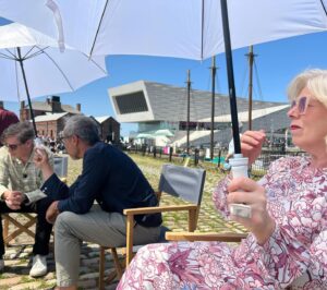 Kate Bryan Instagram - Sky Arts Ice Cream on Location of the year. 🍦 
What a banging day last summer with the good people of Liverpool. Another talented bunch of artists in the pods and well SPF’ed wildcard artists. Yes there were ice creams all round and lots of posing with parasols but it was also a fierce competition and I work very hard ok?! 

Join us at Liverpool docks tonight on Sky Arts at 8pm. 
#laoty #landscapeartistoftheyear #liverpooldocks #tateliverpool thanks to @liz.makeup.11 for keeping me powdered and sun safe ☀️ xxx
