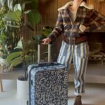 Kate Micucci Instagram - I almost took the wrong navy blue suitcase home from the airport. Went home and drew on it to make sure I wouldn’t do that again. Did my best to be like a Price is Right model to show the product.