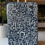 Kate Micucci Instagram - I almost took the wrong navy blue suitcase home from the airport. Went home and drew on it to make sure I wouldn’t do that again. Did my best to be like a Price is Right model to show the product.