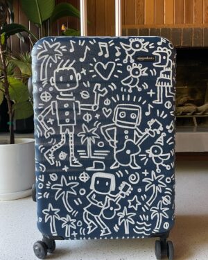 Kate Micucci Instagram - I almost took the wrong navy blue suitcase home from the airport. Went home and drew on it to make sure I wouldn’t do that again. Did my best to be like a Price is Right model to show the product.