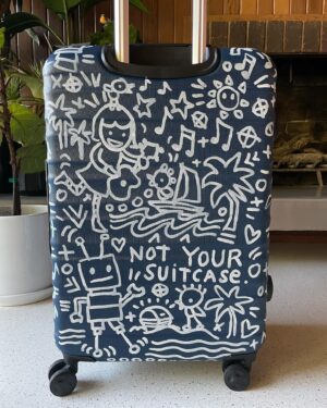 Kate Micucci Instagram - I almost took the wrong navy blue suitcase home from the airport. Went home and drew on it to make sure I wouldn’t do that again. Did my best to be like a Price is Right model to show the product.