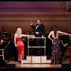 Kelli O'Hara Instagram - #photodump. I’m still misty about this past Friday night with my “partner in crime” @suttonlenore and our evening with @thenewyorkpops led by Maestro @stevenreineke @carnegiehall . There are so many people who made such a grand experiment come off without a hitch, so I must thank them! First of all, the 2 women who inspired the evening (and joined us via
voiceover🥹 ) #dameJulieAndrews and #carolburnett
❤ ❤ . We had wonderful writing and direction by #DickScanlan and additional writing by @katecjames . Our choreographer was the badass @edsciotto and we shared the stage with him and 3 more fabulous friends @ericamansfieldny @sherissespringer and @mrawayne. My right hand man @liptongram was ever by my side as was the incredible #MichaelRafter. It took so much incredible work by folks like our line producer @nikki_fergie and associate director @meganefarley, our orchestrators and everyone @thenewyorkpops to make this happen. I am forever grateful. I also want to thank our stylist @emilysanchezstyle for our #lewks with a huge shout out to @lindsayblockstyle and
@jilloshrymakeup for my #hmu👏 .

My looks in order of appearance:

Opening Dress: @randirahm
Shoes: @stuartweitzman
Bracelet: @Mariajosejewelry
Rings: @shopmodernmoghul

Pink gown with flowers: @Marchesafashion
Shoes: @ninashoes
Rings: @shopmodernmoghul, @itajewelry
Bracelet: @Nadrijewelry

Cowboy look 
Jeans: @everlane 
Shirt: @wrangler 
Boots: Crown vintage co @dsw

Red cocktail dress: @michaelkors
Shoes: @Sam_edelman
Bracelets: @Grownbrilliance, @Aliweissjewelry
Rings: @shopmodernmoghul, @itajewelry 
Earrings: @shopmodernmoghul

Suit: @michaelkors
Shoes: @ninashoes
Rings: @Grownbrilliance
Necklace: @Mariajosejewelry
Earrings: @Nadrijewelry