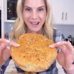 Kelly Kruger Instagram – I finally did it! After 4 tries I MADE A GLUTEN FREE ARTISAN BREAD!🥖 

It’s not like my high protein bread. The texture is like bread bread. 

Who’s trying this? Or just easier to buy it? 

Ingredients:
– 3 cups gluten-free all-purpose flour
– 1 teaspoon salt
– 1 teaspoon instant yeast
– 1 1/2 cups warm water
– 1 tablespoon honey (optional, for a touch of sweetness)
– 1 tablespoon olive oil
– Additional flour or cornmeal for dusting
Seasoning like everything but the bagel 
Instructions:
1. In a large mixing bowl, combine the gluten-free all-purpose flour, salt, and instant yeast.

2. In a separate bowl, mix the warm water and honey (if using) until the honey is dissolved.

3. Gradually pour the wet ingredients into the dry ingredients, stirring as you pour. Mix until well combined. The dough will be sticky and wet.

4. Cover the bowl with plastic wrap and let it sit at room temperature for about 1-2 hours, or until the dough has risen and has a few bubbles on the surface. The rising time may vary depending on the temperature in your kitchen.

5. Preheat your oven to 450°F (230°C). Place a Dutch oven or a heavy oven-safe pot with a lid into the oven as it preheats.

6. Once the oven and pot are preheated, carefully remove the pot from the oven. Sprinkle a little flour or cornmeal on the bottom of the pot to prevent sticking.

7. Scrape the gluten-free bread dough from the bowl onto a piece of parchment paper. Shape the dough into a round loaf, using wet hands to prevent sticking. Place the parchment paper with the dough into the preheated pot.
Top with seasoning of choice. I did everything but the bagel.
8. Cover the pot with the lid and bake for 30 minutes. Then, remove the lid and continue baking for an additional 10-15 minutes, or until the bread is golden brown.

9. Once the bread is baked, carefully remove the pot from the oven and transfer the bread to a wire rack to cool.

#bread #glutenfree #glutenfreebread #recipe #recipepftheday #homecooking