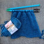 Kirsten Storms Instagram – Knitting by the pool and the end of my needle broke off, so I improvised. Does anyone else carry 3 hair clips and 27 hairbands in their bag? 🤦🏼‍♀️
Anyway, I’m absolutely LOVING the color of this Hometown yarn (“ATHENS BLUE SKY”) by @lionbrandyarn. I’m currently making Harps another sweater – since she no longer fits in all of the other ones I made for her (I will not cry over her growth spurts. I will not.) This sweater will be “oversized” so she can wear it for longer. Giving me the illusion that she isn’t growing. 🤷🏼‍♀️ Gotta do what I can.  Checkout the other Hometown yarn colors if you’re looking to start a new project. It looks like there are some fairly new colors on the Lion Brand website. The blues and greens had me like 🤩🤩. (This is not an ad).