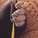 Kirsten Storms Instagram – Almost done crocheting a sweater for Harps (using @lionbrandyarn Pound of Love in “Pumpkin Pie”….this color 😍) While I’m at the last portion of my stay on “sleeve island” I’ve been admiring my new nails by @nails.qvtr.winston. Rhinestones are from @naildadshop and I want to put them on everything I own.  #crochetersofinstagram #nailart #lionbrandyarn