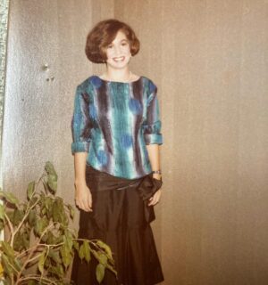 Kitty Flanagan Instagram - Today’s game: Guess how old this lady is? The answer is on p.67 of my book Bridge Burning & Other Hobbies. (And no, I cannot explain the bullet holes in the vertical blinds next to my head.)