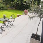 Laura Hamilton Instagram - It's been a while since I've shared some before and after photos of #therebuild so I thought I would start sharing some more. . . . Today I've decided to share a few photos and videos of the garden space. I designed a raised patio at the back and side, with a sunken fire pit. I also created a parking area to the side. . . . I used sandstone tiles from @royalestones and patterned Moroccan tiles from @freelandstilesdg. . . . The area was completed with an outdoor kitchen from @dracogrillsuk, garden furniture from @gardentrendsuk The lanterns and cushions and outdoor decor were from @dunelmuk . . . You might have noticed that I've mentioned in a few posts and stories that 'a change is coming'. I will reveal all very soon. . . . Have a great Sunday. Laura x . . . #garden #gardendesign #home #renovation #inspiration #idealhome #design