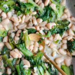 Laura Vitale Instagram - Guagliu, ma che ne sapete de fasul e scarol???? Un piatto classico, cucina “povera” che i ricchi desiderano!! Guys what do know about beans and escarole?!! A classic “cucina povera” dish that the rich desire (as Nonna would say) top classic, you can make it soupy or like this which is incredible on its own with bread and an extra drizzle of strong extra virgin olive oil or on the side of anything (along side sausage is a top fav) everything is by eye, but I’ll do an in depth video on LItK next week! I partially cook my escarole and never would start this dish without anchovies, otherwise my Nonna would revoke my birth certificate 😂 saw @davidroccosvita make a version of this the other day and immediately craved my nonna’s version 🥰