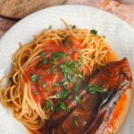 Laura Vitale Instagram – Good ole Italian cooking from the heart is everything!! I stuffed whole eggplant (get small ones for this!) with lots of garlic, parsley and cheese, then simmered in a lovely sugo for a couple hours. It’s like a vegetarian version of bracioletti I kid you not! Joe was convinced the inside was stuffed with meat 🤣 he didn’t believe me when I told him it was just the flesh of the eggplant that soaked up all that beautiful flavor  and got all rich and delish throughout the cooking process. I wanted to add a handful of golden raisins (just like Nonna does in bracioletti which by the way the recipe for those are in my book!) but was fresh out of those. So sensational, I can’t wait to make this again and again with our garden fresh eggplants soon! No real recipe I just cooked from the heart!