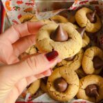 Laura Vitale Instagram – Peanut butter blossoms of dreams!! I have no used any other nut butters or substituted any ingredient, these are the only way I’ve ever made them so if you tailor the recipe know they might not come out the same. It’s also crucial you use a creamy peanut butter (like skippy) and not a natural peanut butter because the end result is not as good. If you plan on freezing the dough,just leave the balls of dough on the baking sheet in the freezer for a couple hours then place then in a large zip lock bag and keep frozen until needed, when you go to bake them bake them at 375 for 10 minutes (you’re just baking them 2 extra minutes) and they are perfection!! 

Yields about 3 dozen 
1/2 cup (one stick) of unsalted butter, softened 
1/2 cup of creamy peanut butter
1/2 cup of granulated sugar 
1/2 cup of brown sugar 
2 tsp of vanilla
2 large eggs 
2 cups of all purpose flour 
1/2 tsp of salt
1 tsp of baking soda 
Chocolate kisses 💋