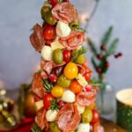 Laura Vitale Instagram – Buongiorno!!!!! See one thing about me is, imma have antipasti at every table 😂 last year they were in the shape of a wreath and this year as Christmas tree!! No recipe obviously just a foam tree wrapped well with plastic wrap and then stab a ton of toothpicks (I find it easier to break them in half) pierce them all around and then attach whatever your heart desires to it. Stay away from oily things as it would make this so messy but it’s just such a show stopper especially if you wanted to make it as a centerpiece to a big charcuterie board. I just love itttt!!!