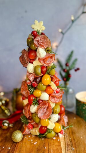 Laura Vitale Instagram - Buongiorno!!!!! See one thing about me is, imma have antipasti at every table 😂 last year they were in the shape of a wreath and this year as Christmas tree!! No recipe obviously just a foam tree wrapped well with plastic wrap and then stab a ton of toothpicks (I find it easier to break them in half) pierce them all around and then attach whatever your heart desires to it. Stay away from oily things as it would make this so messy but it’s just such a show stopper especially if you wanted to make it as a centerpiece to a big charcuterie board. I just love itttt!!!