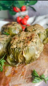 Laura Vitale Instagram - In this house, we keep recipe traditions alive especially around the holidays. Artichokes are alwaysssssssss on the table at Easter, either boiled (or steamed) or stuffed (and most of the time both) and they are so sensational you can’t even imagine!! I don’t really measure the filling (but i hope to shoot it for you in depth this week if time allows because I make them all spring long!!) breadcrumbs , cheese, garlic, parsley, lots of oil and good pinch of salt. Cook low and slow in enough water and to come up half way and a good drizzle of oil and healthy pinch of salt. Keep topping off the water to keep it at that halfway mark, cook about an hour and if you’d like (and I recommend) broil for a few minutes. Serve with some of the brothy water drizzled over the top and live your best life one bite at a time babes 😍