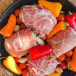 Laura Vitale Instagram - Dinner can be easy peasy if you make this! Season some chicken with some garlic and herb then stuff with a little flavored spreadable cheese situation, wrap it in a prosciutto (I also did 2 pancetta wrapped) blanket, surround with tomatoes, peppers, garlic (I would have added shallots and olives but was out) drizzle with olive oil and bake at 425 for like 40 minutes. Some of the cheese oozes out, mixes with the juicy veg and creates its own sauce. I served mine with angel hair (not a fav of mine but joe loves it) tossed in that sauce with a tbsp of added butter and a handful of cheese and y’all I just about needed to be resuscitated !!!! It was SOOOOOO good! You must must give it a try!