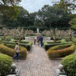 Lauren Liess Instagram – Garden dreaming at the @elizabethangardens 🌿 one of my favorite places to visit- especially in the winter when I’m really missing the green. Live oaks, budding daffodils   a forest full of blooming star magnolias & camellias greeted us this time. I love being down in the Outer Banks and this trip was no exception 🌊 it’s always good for the soul. My next book – BEACH LIFE- comes out the weekend before Memorial Day to kick off the summer and it’s all about beach life- interiors, people   places   food, and how our minds   bodies are affected by being near the ocean and how we can use that special time to find our truest selves 🤍 it’s filled with personal stories (lol goes way back to when D and I first met, chronicles how we found and fixed up @thelostcottage and finishes off with our most recently finished project- Dune House- and how some healing has been needed after that one.) BEACH LIFE: HOME, HEART & THE SEA is available now on preorder and I really think you’ll love this one 🤍 ok and one PSA because it’s that time of year again and because it’s in these pictures- NO. MORE. “crepe murder!” Lol PLEASE just don’t do it to your crepe myrtles!!! 🤣🤗