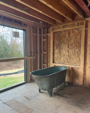 Lauren Liess Instagram - The CORRECT 200-something-year-old tub has arrived at the Meadow!! 🛁And it is green!! (Phew!!) I’ve been going back and forth internally on its positioning… I have always planned for it to span left-to-right in front of the back window (1st video/ 2nd slide) but can’t forget how much I loved baths in our old tub which faced straight out out a (side) window so I’ve been wrestling with facing it towards the back window (3rd   4th slides). The glass door to the left side will lead to a walled-in garden with outdoor showers in it and the back window (not in yet) looks out to the back yard. I love the silhouette of the tub when it’s sideways and space-wise it fits the room perfectly but I can’t unsee the thought of those facing those views straight on. Here it is both ways and I’m 99.9% on team facing the views now. It somehow feels more authentic to me, having the tub face the way we will naturally want to look but I’m a little sad to see less of the tub straight on and I don’t love having my back to the room. Something I’ve written a bit about in the past is that there are some spaces where the “enjoyment” arrangement (the one you will be using and enjoying while in the space) isn’t as pretty upon entry or to look at… in these cases I think about pros and cons (enjoyment in the room usually wins unless it’s just way too awkward-feeling.) I’ll be posting a video update of our final decision once it’s made… what would you do?? Are you on Team sideways or Team Views?? 🫧 {Also, if you haven’t seen it, our first Meadow House episode is up on y o  u. T ube!