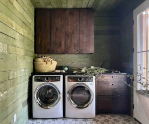 Lauren Liess Instagram - Sharing some of my favorite goods from my shop @laurenliessandco today in stories 🤍🌿 looooove our handmade laundry baskets and don’t mind so much when they’re hanging our full of clothes to fold 😉 most of my favorite shop good are beautiful, functional items since the reality is that our interiors are full of the functional - it may as well look good! 🤍🌿 This the laundry room from our #wisconsinfarmhouseproject. Our client painted the old boards with green milk paint and the cabinets are the “primitive” from my collection with @uniquekitchensandbaths | photo by @helennorman