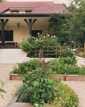 Lauren Liess Instagram - They started digging for the garden walls at the Meadow (they are currently held up waiting for final okay from power company!) and my mind is on our vegetable garden!! I cannot WAIT to get planting!!! I’m leaning towards doing gravel with the same boxes with top ledges we had at our old place (pictured here) because it was really nice to be able to sit down and weed or relax. The kids also loved walking along them 😉 I wanted a terracotta roof so badly at the Meadow but it turned out that the existing structure couldn’t support the weight so we went with cedar instead and I’ll be sharing how that turned out soon on our you t. U Be channel. 🤍🌿
