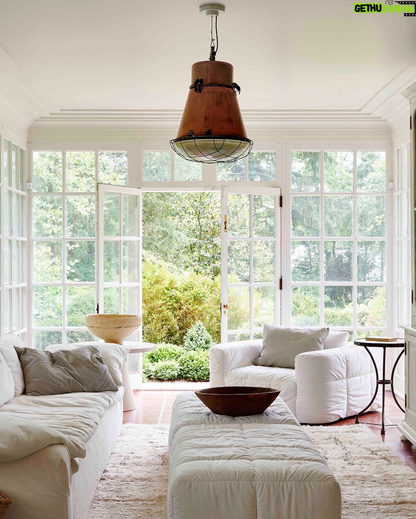 Leanne Ford Instagram - At home with my Mellow Chairs — part two! Our home’s sun room has become the room where my family and I like to cozy up together the most. We read books, watch shows, color and just get really cozy, cozy, cozy here! So, when I got my hands on some samples of the Mellow Chair that I’d been designing with @crateandbarrel (in the hope to create the coziest chair imaginable), I knew they had to go in this room! I paired the Mellow Chair with my Ever Sofa and even swapped out the coffee table that was originally here for two of the Mellow Ottomans lined up next to one another — now we can quite literally kick our feet up and relax here. This room was always a space that we naturally gravitated to and now we just might never leave! // #LeanneForCrate shot by @amyneunsinger with interior styling by @hilaryrobertson