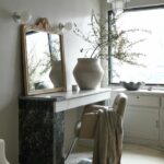 Leanne Ford Instagram - When we got started on this project they had already painted the walls and epoxied the floors, so we made that our main source of inspiration — leaning into all the warm earthy tones already there. To do this we found all these salvaged marble pieces and pieced them together to make different pieces of furniture like the vanity you see here. Anything can be anything! Swipe to see the marble graveyard we pulled all of these pieces out of — it was our kind of gold mine (ya know how it goes....one man’s trash, another man’s treasure)! //#LeanneFordInteriors shot by @erinashkelly and styled @_mon_modern______