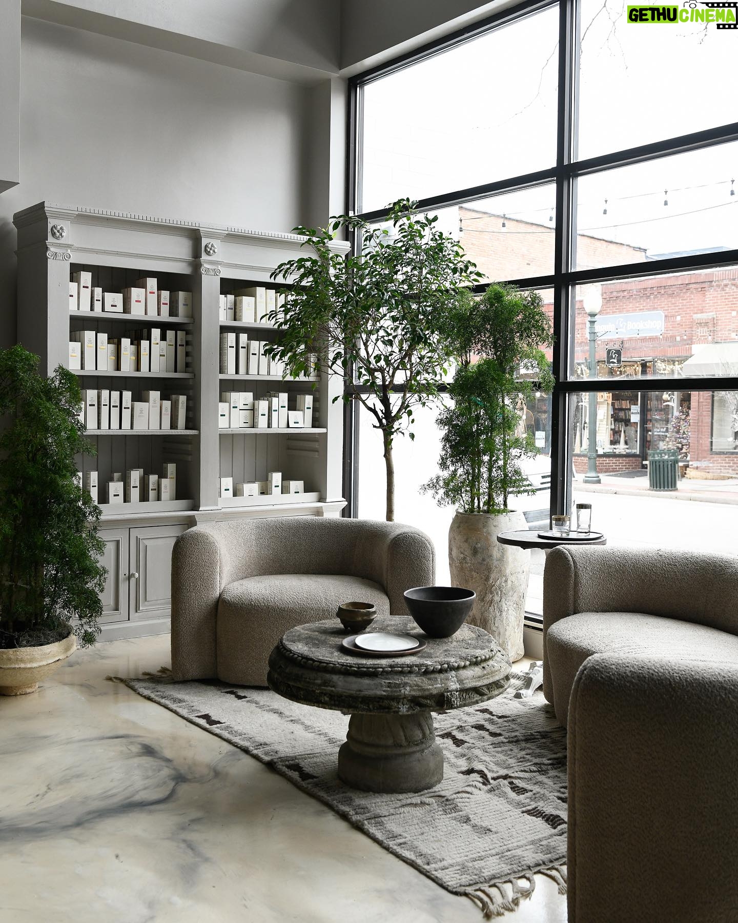 Leanne Ford Instagram - When we moved back to our little town right outside of Pittsburgh I told anyone who wants to open (or update!) a business around here that I would love to help. I want to do my part to see our town flourish and grow. Sarah Pelco took me up on the offer for her Salon! And I’m so glad. Such a fun project and a great addition to Sewickley. The starting points of the salon were already there when we walked in. They had already begun painting the walls a lovely gray. (Not my usual choice, so it was fun to go with it!) We decided to keep and work with the previous tenants’ epoxied floor, feeling like the grays of the wall made it feel richer than expected. Since a salon usually feels feminine in nature, it was fun to play with a more “masculine” edge in this space — mixing soft elements like the curves and fabric on this sofa with loads of stone, vintage and earth elements throughout the space. We also painted this vintage cabinet the same exact paint color as the walls to simplify the eye. And my Hugger Collection for @crateandbarrel comes in this yummy taupe option which tied the whole shebang together. //#LeanneFordInteriors shot by @erinashkelly and styled @_mon_modern___
