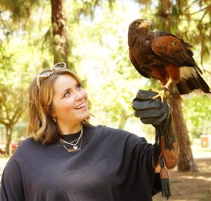 Lee Newton Instagram - Was I 💯 convinced that this Hawk was a human man trapped in a bird body and needed me to break his bird curse with a smooch. Yes. Can you see the palpable sexual tension betwixt the two of us in these photos- UHHH, YES. Thank you @hawkonhand for introducing us, and for such an educational, delightful time! (Legitimately if you’re in the LA  area this was such an INCREDIBLE EXPERIENCE!!! Do it!!!) 
Ps. The owls name is Archie 🥹🦉!!!