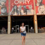 Lola Kirke Instagram - First trip to the Opry a few years back 🥹 @schecibaby made me pose in front of the entry for this photo just in case one day this day came ❤️ now it’s here! I’m so excited and def going to get highlights Link in bio for more info on how to attend in person or tune in from home!