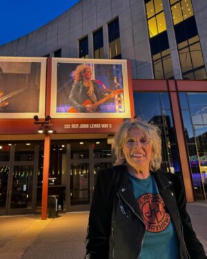 Lucinda Williams Instagram - Went to see a beautiful performance this past weekend by our good friends T-bone Burnett @tboneburnettofficial , Colin Linden @howlinformydarlin , David Mansfield @davidmansfieldmusic , Larkin Poe @larkinpoe , and Dennis Crouch @mrbigbass at the Country Music Hall of Fame. Absolutely stunning night of music. Had to take the opportunity to get my photo in front of the billboard at the @countrymusichof ❤️‍🔥

If you can, try to get over there to see the American Currents: State of the Music exhibition, which includes displays and memorabilia from Taylor Swift, Tyler Childers, Lainey Wilson, and many, many more (including yours truly 🤘🥰)