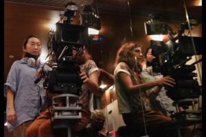 Lulu Wang Instagram - #Director Lulu Wang (@thumbelulu) and #DOP Anna Franquesa-Solano AEC (@annafranquesasolano) take us #behindthescenes of #Expats, shot with #Panaspeed lenses and serviced by #Panavision Woodland Hills.

Anna begins: 
“We wanted to capture a sense of restraint, since the three protagonists are constantly making an effort to not let go or surrender to their emotions, knowing that if they do, they will get lost. It is this attempt to keep control over their lives that influenced much of the visual look—subdued and constrained.”

Lulu continues: 
“Anna and I watched films together and also referenced photographers Michael Wolf and Christopher Anderson. We discussed how we’d visually represent this wound, this unseen thing. We also talked a lot about the contrast of the different worlds and spending a lot of time on the ground in Hong Kong gave us a lot of inspiration.”

Anna continues: 
“The reason why I went to Panavision for this project is because they have some of the best glass in the world and they were open to work with me to develop and find the look. The Panaspeeds gave us the control over the image that felt appropriate for the look. After performing some tests, Dan Sasaki modified them to be less sharp, softening the bokeh, controlling the flare to a minimum, and having very subtle glare around highlights, so we didn’t need any filtration during the shoot. 
We kept the look very clean, with no aberrations or flares to soften the reality that these women have to go through.”

Lulu concludes:
“The scale of EXPATS was far greater than anything I’ve done before, and it gave us a ton of runway to play with different visual languages and thematic ideas. It was important for us to be expansive without losing the intimacy or specificity for each character and their particular world. 

I became a director because I wanted to tell stories that transport you to another world and into another perspective. What keeps me inspired these days is collaboration. I love how collaboration expands my worldview and it helps me to continue learning and growing.”