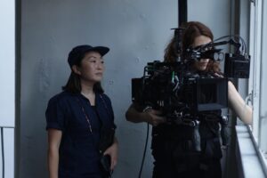 Lulu Wang Instagram - #Director Lulu Wang (@thumbelulu) and #DOP Anna Franquesa-Solano AEC (@annafranquesasolano) take us #behindthescenes of #Expats, shot with #Panaspeed lenses and serviced by #Panavision Woodland Hills.

Anna begins: 
“We wanted to capture a sense of restraint, since the three protagonists are constantly making an effort to not let go or surrender to their emotions, knowing that if they do, they will get lost. It is this attempt to keep control over their lives that influenced much of the visual look—subdued and constrained.”

Lulu continues: 
“Anna and I watched films together and also referenced photographers Michael Wolf and Christopher Anderson. We discussed how we’d visually represent this wound, this unseen thing. We also talked a lot about the contrast of the different worlds and spending a lot of time on the ground in Hong Kong gave us a lot of inspiration.”

Anna continues: 
“The reason why I went to Panavision for this project is because they have some of the best glass in the world and they were open to work with me to develop and find the look. The Panaspeeds gave us the control over the image that felt appropriate for the look. After performing some tests, Dan Sasaki modified them to be less sharp, softening the bokeh, controlling the flare to a minimum, and having very subtle glare around highlights, so we didn’t need any filtration during the shoot. 
We kept the look very clean, with no aberrations or flares to soften the reality that these women have to go through.”

Lulu concludes:
“The scale of EXPATS was far greater than anything I’ve done before, and it gave us a ton of runway to play with different visual languages and thematic ideas. It was important for us to be expansive without losing the intimacy or specificity for each character and their particular world. 

I became a director because I wanted to tell stories that transport you to another world and into another perspective. What keeps me inspired these days is collaboration. I love how collaboration expands my worldview and it helps me to continue learning and growing.”