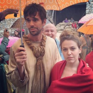 Majandra Delfino Instagram - Had a lot of questions come in about the whole “Game of Thrones Cut” where David and I didn’t make it as extras in an episode. Let me tell you MY side of the story, as @davidwalton and I, in a classic married couple conundrum, remember the events very differently. We flew from LA to Peniscola Spain (that’s pronounced PENIS cola, don’t miss that fine opportunity to repeat aloud...a lot) which was a butt long trip in the air, coupled with the five hour drive from Madrid to aforementioned penis place. When we arrived at the hotel at around midnight, we were given our call time of 8am. Jet lag be damned, the real wake up call for me was the realization that we’d gone through all this trouble (and left our infant children) not to eat Jamón and enjoy Spain. No. We were there to work. And as “background artists” nonetheless. As a quasi successful actor, I’ve grown to realize there’s very little else more demoralizing than witnessing the difference in treatment when I’m on set vs my husband. Whatever, he may be prettier and much nicer, but I’ve worked longer! And have an Alma award G-d damn it! I’m right here! Standing right next to him!! (He’s also 6’4 and I’m 5’6” and I always have a pouty expression but THATS NOT THE POINT) I digress. So there I was, absorbing the reality that I was going to be waking up butt ass early, dress as a slave girl, and experience that same “oh...and the wife” dynamic. BUT AS EXTRAS. And for those of you who work on sets (and everybody CHILL) but a lot of times background artists bring out some of the more crazy people in the town. And to say I have PTSD about the whole thing wouldn’t suffice (@shug_life_sfv Feel free to back me up on all we’ve experienced together in this department). So in two words my feelings were: No. Grathias. But I love my husband. And I loved his innocence in thinking we’d ever make it on the show and not be cut out immediately. So I did the damn thing. And then after it started to get too repetitive, too cold and the local espresso places started opening, I lost the plot. The smooth smell of a local crema beckoned me. So I walked over to Benioff and said “let’s be real, I can sneak off, yes?” (Cont.)