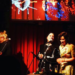 Maria Doyle Kennedy Instagram - I can’t tell you what a magnificent experience it was playing live again, that I made myself a feather crown might be some indication I suppose 😊 , so many feelings , ALL the feels. Thank you to everyone for coming to see us, especially those who braved such long journeys . Thank you Robert, Andrea #Parterre , Henri and Michael #CafeBarMokka , Viktor and Marten #ElLokal . #LiveMusic #community #❤️

The first photo was taken on our very first Swiss tour in 1992 , Sunday’s feather crown, onstage with Erica Stucky #ElLokal 2020 , all the band (Jimmy Bastard) that we toured with in 1992 came to our show on Sunday night, walking home after the gig xxx