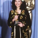 Mary Steenburgen Instagram - A word about the Oscars on Sunday night. As a Best Supporting Actress Winner, I was asked to speak about my friend, Emily Blunt and her fierce and heartbreaking work in Oppenheimer. From the stage I could see Emily, shining in this moment and John, fighting back tears in his pride of her and Ted, a few feet away, beaming at me. I felt the feeling that I often do on our sets. How in the world did I end up here? It still all fills me with wonder and gratitude. So that’s what was going on in the inside. As far as what was going on on the outside… I loved this sleek @tomford dress that my brilliant stylist @itsamandalim found. Shoes @ralphlauren, bag @judithleiberny, earrings @ireneneuwirth, bracelet @cathywaterman, green string bracelets by my three granddaughters. Dreamiest glam team: @davestanwell, @lorencanbymakeup, @miadonderomakeup. Styling assistants @_shmian, @robwolfflund. Alterations @martinzepedadesigns. Thank you’s: Annett Wolf (goddess), Lauren Appel, Allie Jenkins, Olivia Gafford, Emma Kreisberg, and Jessica Mallari; Eric Kranzler for letting me get dressed in your stunning house. It always feels like Sinatra could walk in at any moment; and Jonah Koppelman. A special thank you to Molly McNearney, who knew of my friendship with Emily Blunt, and had the much appreciated idea of including me in honoring her. Thank you @badgleymischka, I loved wearing that dreamy pleated dress to the Vanity Fair party. The stunning orange necklace, bracelet, and earrings by @ireneneuwirth, my gold bracelet by @cathywaterman, green string bracelets by my granddaughters. Vegan coat @rachelantonoff. And in the privacy of our bedroom, as we were getting out of our Vanity Fair looks sometime after midnight, thank you @teddanson for singing and dancing to the song “I’M JUST TED”. In an evening full of highlights, this one topped them all! Last two photos: DisneyABC via Getty.
