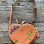 Melanie Lynskey Instagram - I got to have a poppet date night on Wednesday and celebrate the launch of this amazing collaboration between @coach and @observedbyus and @kirstendunst. These pieces are so special and so unique and beautiful, clearly made with love and as a result of such a sweet friendship. There are ants on this heart bag!! It’s so charming! Every person at the dinner was wonderful and it really felt like hanging out with friends. You know how people always ask “who would you have at your dream dinner party?” Well now I know my answer, and it includes @stuartvevers @domfishback @observedbyus @kirstendunst and Jesse @hilaryduff @matthewkoma @negga.ruth @addison.timlin @evanrosskatz and my poppet @magslawslawson. And getting to congratulate Dom on the Emmy nomination I NEEDED to happen was so joyous. Feels a bit funny to post about anything other than the strike, but this really was a special night and is a super lovely collaboration and I wanted to say thank you 💖 Hair!! @dickycollins- makeup! @kristeeliu - styling and running all over town! @misha_rudolph_stylist Images: @bfa @jojo_jpeg @matthewyoscary Edited to say these shoes are also @coach !! Because people are rightfully very excited about the shoes