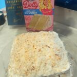 Melissa Peterman Instagram - @dollyparton helped me bake a coconut cake today. Yes, I toasted the coconut. I didn't hear her say "groundbreaking choice" but I felt her approval from the box. #delicious #dollyparton #dollypartonduncanhinescake @realduncanhines #coconutcake