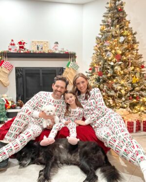 Michelle West Instagram - “Merry Christmas Eve Eve” IYKYK 😆 With a hectic few weeks, we didn’t manage to get the pics I envisioned yet but these put a smile on my face and we had fun while capturing them! Bernie on the other hand, over it 😂

#matchingpajamas #familyfirst #christmaspajamas #positiveinfluencer #teamwest #familymatching