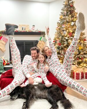 Michelle West Instagram - “Merry Christmas Eve Eve” IYKYK 😆 With a hectic few weeks, we didn’t manage to get the pics I envisioned yet but these put a smile on my face and we had fun while capturing them! Bernie on the other hand, over it 😂

#matchingpajamas #familyfirst #christmaspajamas #positiveinfluencer #teamwest #familymatching