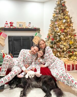 Michelle West Instagram - “Merry Christmas Eve Eve” IYKYK 😆 With a hectic few weeks, we didn’t manage to get the pics I envisioned yet but these put a smile on my face and we had fun while capturing them! Bernie on the other hand, over it 😂

#matchingpajamas #familyfirst #christmaspajamas #positiveinfluencer #teamwest #familymatching