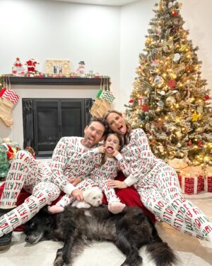 Michelle West Instagram - “Merry Christmas Eve Eve” IYKYK 😆 With a hectic few weeks, we didn’t manage to get the pics I envisioned yet but these put a smile on my face and we had fun while capturing them! Bernie on the other hand, over it 😂

#matchingpajamas #familyfirst #christmaspajamas #positiveinfluencer #teamwest #familymatching