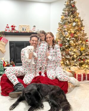 Michelle West Instagram - “Merry Christmas Eve Eve” IYKYK 😆 With a hectic few weeks, we didn’t manage to get the pics I envisioned yet but these put a smile on my face and we had fun while capturing them! Bernie on the other hand, over it 😂

#matchingpajamas #familyfirst #christmaspajamas #positiveinfluencer #teamwest #familymatching